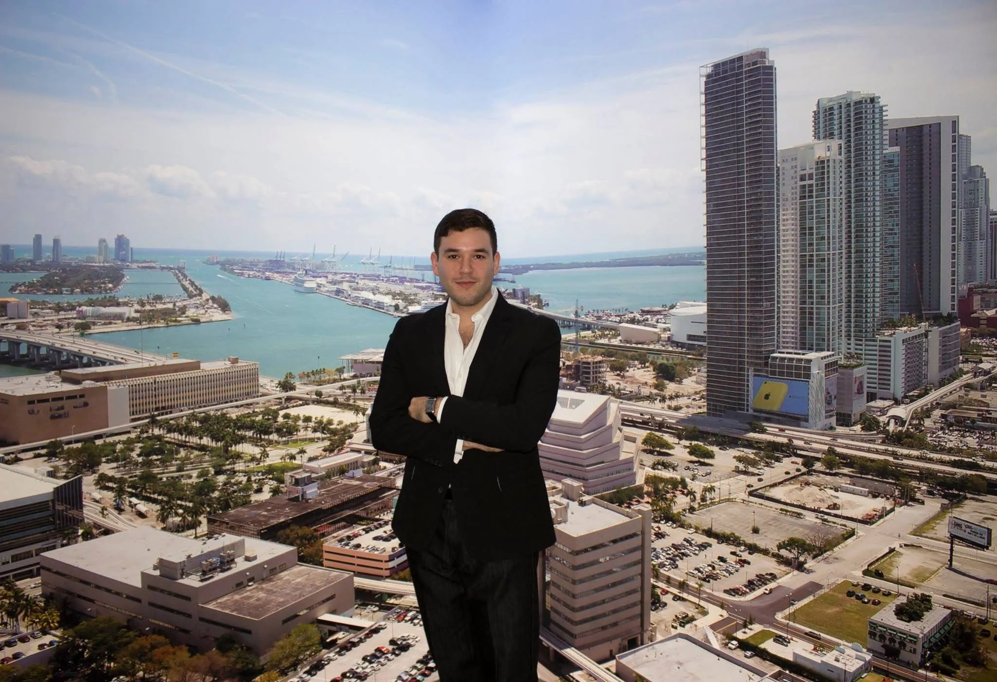 Andrew on a rooftop overlooking the Miami skyline